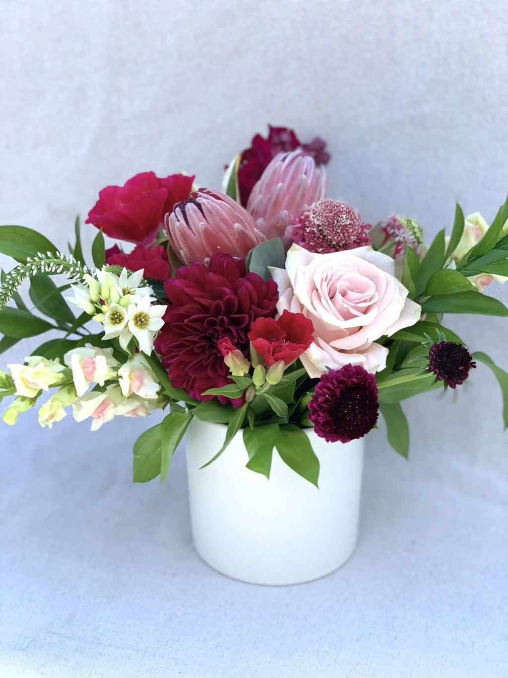 flower delivery centerpiece in burgundy and white