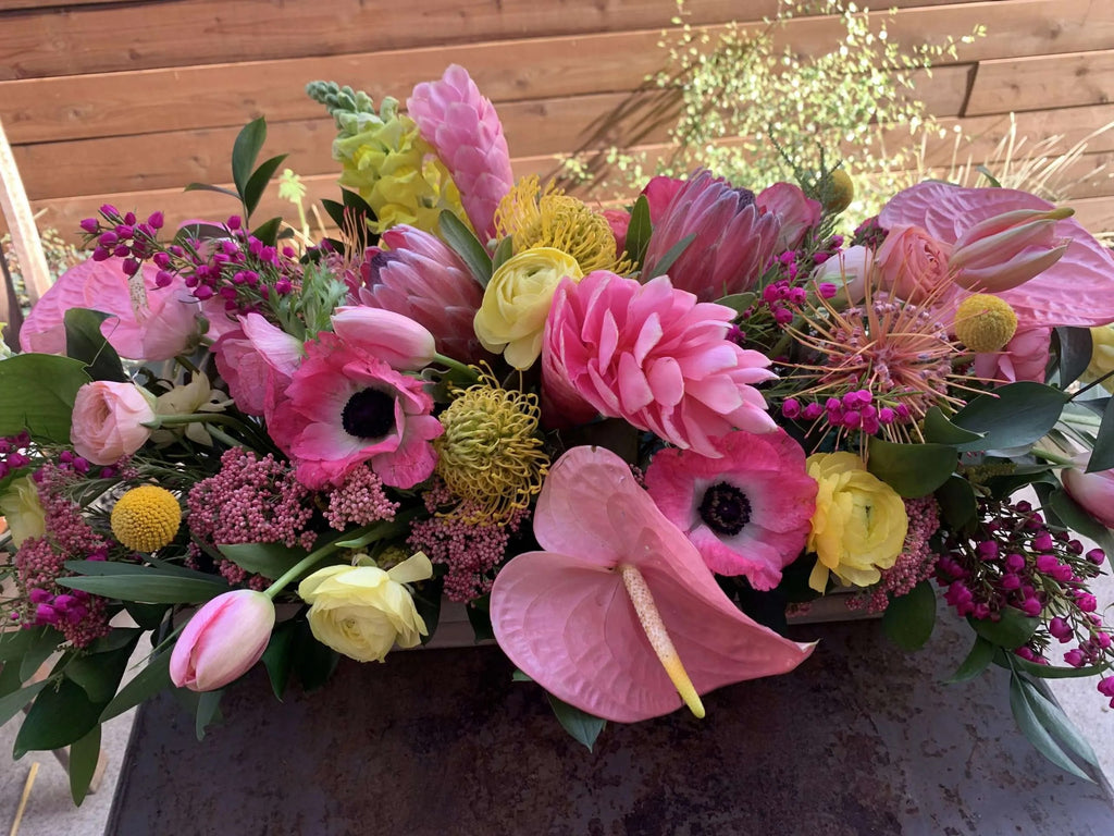 flower delivery centerpiece in pinks and yellows